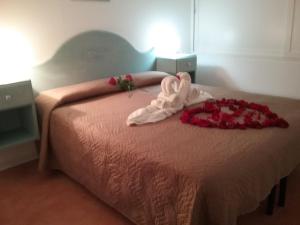 a bedroom with a bed with a pink bedspread at Villa Eden IUN Q0499 in Santa Margherita di Pula