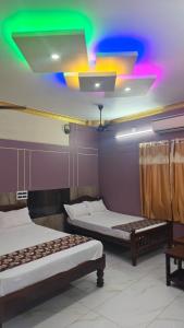 Ένα ή περισσότερα κρεβάτια σε δωμάτιο στο Guru Residency Pondicherry