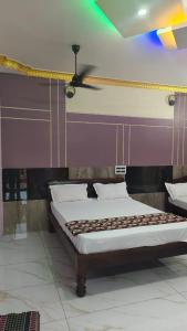 Ένα ή περισσότερα κρεβάτια σε δωμάτιο στο Guru Residency Pondicherry