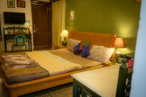 Giường trong phòng chung tại Green Bramda