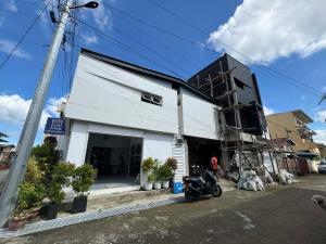 a building under construction with a motorcycle parked in front at rõõm collective in Odiongan