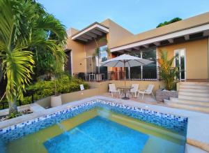 a swimming pool in front of a house at Cerros de Anapoima in Anapoima