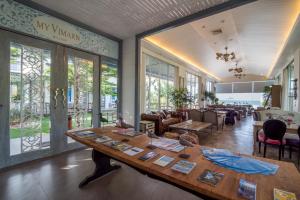 a room with a large wooden table and chairs at My Resort Hua Hin Service Apartment with Seaview in Hua Hin