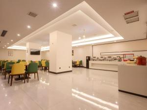 a waiting room with chairs and a table in a building at Green Tree Inn Nanchang Zhongshan Road Bayiguan in Nanchang