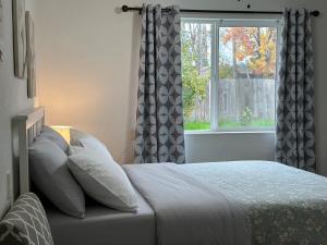 a bedroom with a bed with pillows and a window at Cozy suite B in Sacramento +2 photos