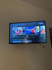 a flat screen tv hanging on a wall at Davit's Apartments 21 in Tbilisi City