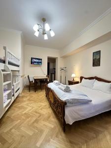 a bedroom with a bed and a desk with a piano at Davit's Apartments 21 in Tbilisi City