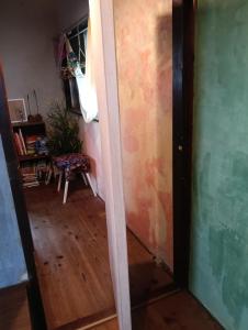 a hallway with a door and a room with a table at BAz11 in Misaki