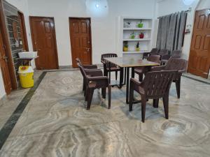 a dining room with a table and chairs at Magadh Homestay in Patna