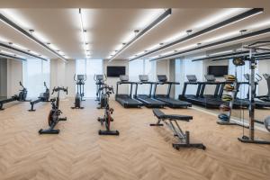 a gym with treadmills and elliptical machines at Hyatt Place Cancun Airport in Cancún