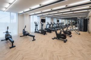 a gym with a bunch of treadmills and ellipticals at Hyatt Place Cancun Airport in Cancún +75 photos