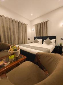 a hotel room with two beds and a couch at Venture Vista Gulmarg in Jāmb