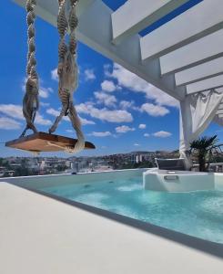 a view from the balcony of a house with a swimming pool at One 360 Skyline Athens Penthouses in Athens +80 photos