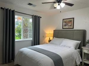 a bedroom with a bed with a ceiling fan and a window at Kitchen Suite A in Sacramento +18 photos