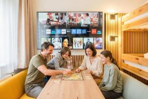 a group of people sitting at a table playing a game at Hotel Nummerhof in Erding