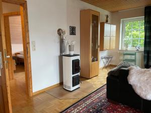 a living room with a room with a stove in it at Mein Sauerland in Medebach