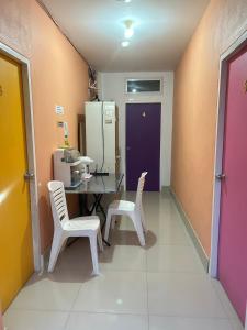 a room with a table and chairs and a refrigerator at MyHome 3P Room in Ban Komo Sip Paet