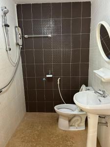 a bathroom with a toilet and a sink at MyHome 3P Room in Ban Komo Sip Paet
