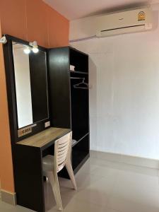a bathroom with a vanity with a mirror and a chair at MyHome 3P Room in Ban Komo Sip Paet