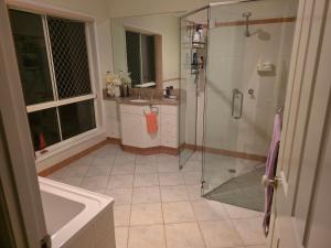 a bathroom with a shower and a sink at Gaven Garden in Gold Coast