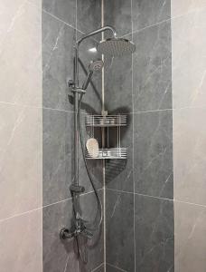 a shower with a shower head in a bathroom at Hilltop Hotel Gusar in Qusar +65 photos