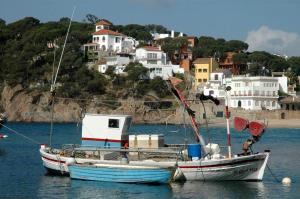 two boats are docked in a body of water at LLAFRANC 100 - calle Coral- in Llafranc