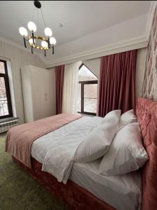 a bedroom with a large bed with a window at Hilltop Hotel Gusar in Qusar