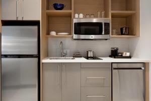 a kitchen with a sink and a microwave at Quality Inn & Suites Prescott in Prescott