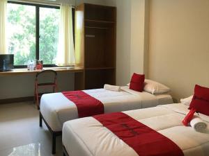 En eller flere senge i et værelse på RedDoorz Plus @ Bitung City Center