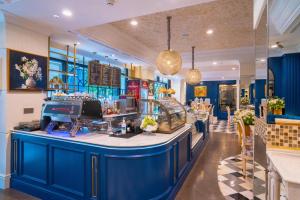 a bar in a restaurant with a blue counter at Le Meridien Jakarta in Jakarta