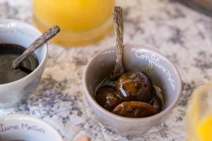 a bowl of food with two spoons in it at Campagne de la source St Martin B&B in Cotignac