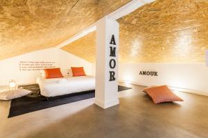 a room with two beds and an art exhibit at The Love Tram Apartment in Lisbon