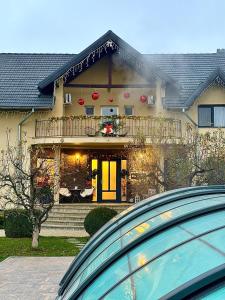 a large house with a balcony on top of it at Orchard Villa in Braşov