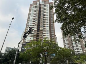 a tall building with a traffic light in front of it at Trăng Khuyết 404MD in Hanoi