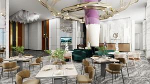 a restaurant with tables and chairs and a large chandelier at The Everly Lhesson Kuching in Kuching