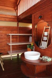a bathroom with a sink and a mirror at Cabo Serai in Canacona +24 photos