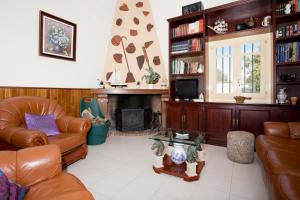 a living room with leather furniture and a fireplace at Casa Julia Llucmajor in Llucmajor