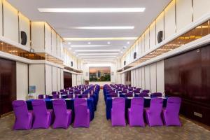 a row of purple chairs in a room at Park Lane Hotel in Shunde