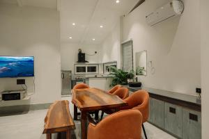 a living room with a table and chairs and a tv at Vanilla Country in Dibrugarh