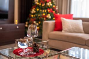 a living room with a christmas tree and two wine glasses at Yaya Hotel & Apartments in Nairobi