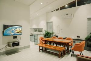 a dining room with a wooden table and chairs at Vanilla Country in Dibrugarh