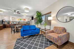 a living room with a blue couch and a chair at Quality Inn Dubuque on Hwy 20 in Dubuque