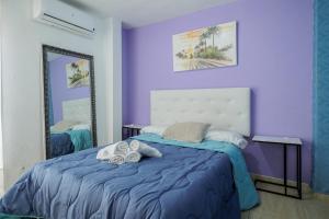 En eller flere senge i et værelse på Duque Center Premium Suites