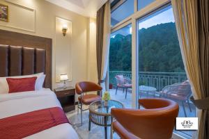 una habitación de hotel con una cama y una ventana grande en Blackpearl Sparklewoods, en Kasauli 46 fotos más