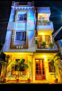 a lit up building with plants in front of it at The Dreams sea view in Puducherry