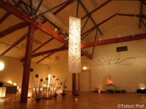 a large room with a light hanging from the ceiling at Misasa Royal Hotel in Misasa +108 photos