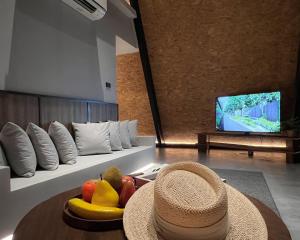 a room with a bowl of fruit and a hat on a table at Khunkhao Paradise Khao Yai in Ban Rai Khlong Sai