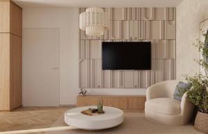 a living room with a tv and a chair and a coffee table at Apartment Solis 8 in Stara Novalja