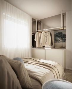 a bedroom with a bed and a window and a clothes rack at Apartment Solis 8 in Stara Novalja