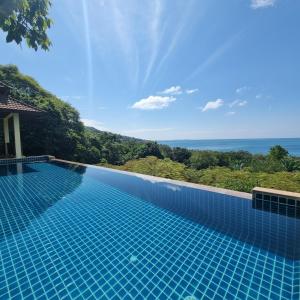 a swimming pool with a view of the ocean at The Great Escape Pool Seaview Villa in Ko Lanta